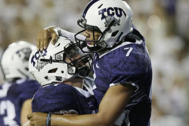 TCU quarterback Kenny Hill (7) celebrates rushing for a touchdown with teammate center Austin Schlottmann during the second half of an NCAA college football game against South Dakota State on Saturday, Sept. 3, 2016, in Fort Worth, Texas. TCU won 59-41. (AP Photo/LM Otero)