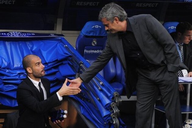FC Barcelona's coach Pep Guardiola, left, shakes hands with Real Madrid's coach Jose Mourinho, from Portugal, ahead of their semifiinal first leg Champions League soccer match at the Bernabeu stadium in Madrid, Spain, Wednesday, April 27, 2011. (AP Photo/Manu Fernandez)