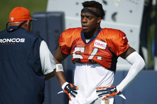 Denver Broncos inside linebacker Brandon Marshall, right, confers with linebackers coach Reggie Herring during a break in drills at the team's NFL football training camp Saturday, July 30, 2016 in Englewood, Colo. (AP Photo/David Zalubowski)