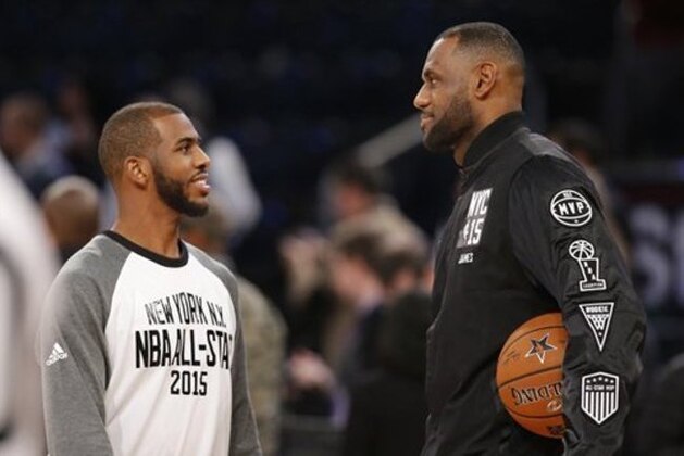 East Team's LeBron James, right, of the Cleveland Cavaliers, talks to West Team's Chris Paul, of the Los Angeles Clippers, prior to the start of the NBA All-Star basketball game, Sunday, Feb. 15, 2015, in New York. (AP Photo/Kathy Willens)