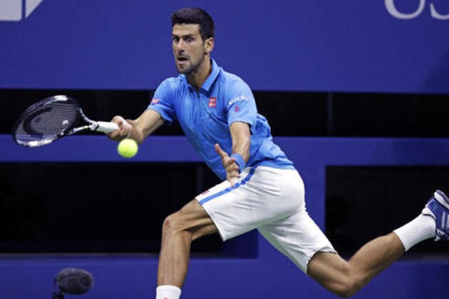 Novak Djokovic, of Serbia, hits a return to Jo-Wilfried Tsonga, of France, during a quarterfinal round match at the U.S. Open tennis tournament, Tuesday, Sept. 6, 2016, in New York. (AP Photo/Charles Krupa)