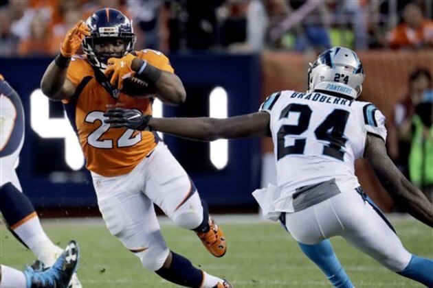 Denver Broncos running back C.J. Anderson (22) tries to escape the reach of Carolina Panthers cornerback James Bradberry (24) during the first half of an NFL football game, Thursday, Sept. 8, 2016, in Denver. (AP Photo/Jack Dempsey)