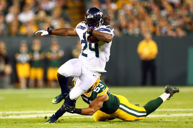 GREEN BAY, WI - SEPTEMBER 20:  Marshawn Lynch #24 of the Seattle Seahawks runs the ball against  Nick Perry #53 of the Green Bay Packers during the first quarter in their game at Lambeau Field on September 20, 2015 in Green Bay, Wisconsin.  (Photo by Maddie Meyer/Getty Images)