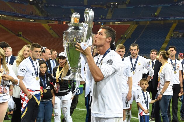 Real Madrid's Portuguese forward Cristiano Ronaldo kisses the trophy after Real Madrid won the UEFA Champions League final football match over Atletico Madrid at San Siro Stadium in Milan, on May 28, 2016. / AFP / GERARD JULIEN        (Photo credit should read GERARD JULIEN/AFP/Getty Images)
