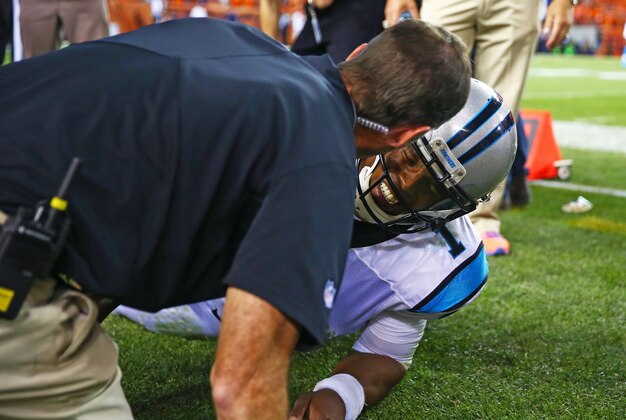 Sep 8, 2016; Denver, CO, USA; Carolina Panthers quarterback Cam Newton (1) reacts in pain on the sidelines after suffering an injury in the third quarter against the Denver Broncos at Sports Authority Field at Mile High. Mandatory Credit: Mark J. Rebilas-USA TODAY Sports