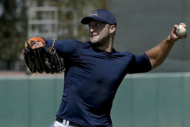Former NFL quarterback, Tim Tebow throws a ball for baseball scouts and the media during a showcase on the campus of the University of Southern California, Tuesday, Aug. 30, 2016 in Los Angeles. The Heisman Trophy winner works out for a big gathering of scouts on USC's campus in an attempt to start a career in a sport he hasn't played regularly since high school. (AP Photo/Chris Carlson)