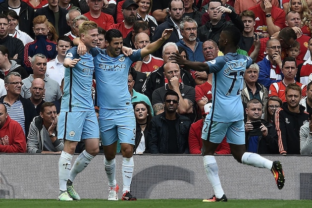 Manchester City's Belgian midfielder Kevin De Bruyne (L) celebrates with Manchester City's Spanish midfielder Nolito (2nd L) and Manchester City's Nigerian striker Kelechi Iheanacho after scoring the opening goal in the English Premier League football match between Manchester United and Manchester City at Old Trafford in Manchester, north west England, on September 10, 2016. / AFP / Oli SCARFF / RESTRICTED TO EDITORIAL USE. No use with unauthorized audio, video, data, fixture lists, club/league logos or 'live' services. Online in-match use limited to 75 images, no video emulation. No use in betting, games or single club/league/player publications.  /         (Photo credit should read OLI SCARFF/AFP/Getty Images)