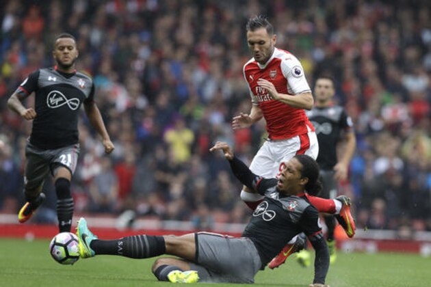 Arsenal's Lucas Perez vies for the ball with Southampton's Virgil van Dijk, front, during the English Premier League soccer match between Arsenal and Southampton at Emirates stadium in London, Saturday, Sept. 10, 2016. (AP Photo/Kirsty Wigglesworth)