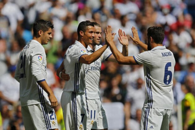 Real Madrid's Cristiano Ronaldo, second left, celebrates with teammates after scoring the opening goal against Osasuna during the Spanish La Liga soccer match between Real Madrid and Osasuna at the Santiago Bernabeu stadium in Madrid, Saturday, Sept. 10, 2016. (AP Photo/Francisco Seco)