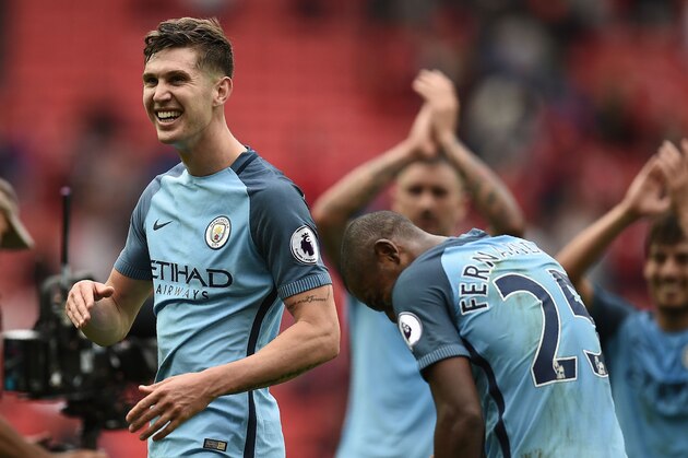 Manchester City's English defender John Stones (L), and teammates celebrate on the pitch after the English Premier League football match between Manchester United and Manchester City at Old Trafford in Manchester, north west England, on September 10, 2016.
Pep Guardiola savoured a derby success over arch-rival Jose Mourinho on Saturday as Manchester City beat Manchester United 2-1 in an engrossing Premier League clash.
 / AFP / Oli SCARFF / RESTRICTED TO EDITORIAL USE. No use with unauthorized audio, video, data, fixture lists, club/league logos or 'live' services. Online in-match use limited to 75 images, no video emulation. No use in betting, games or single club/league/player publications.  /         (Photo credit should read OLI SCARFF/AFP/Getty Images)