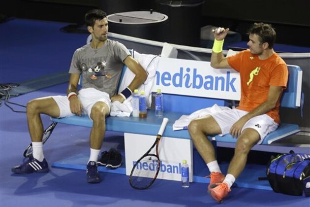 Serbia's Novak Djokovic, left, and Switzerland's Stan Wawrinka talk during a break in a training session on Rod laver Arena ahead of the Australian Open tennis championships in Melbourne, Australia, Thursday, Jan. 14, 2016.(AP Photo/Mark Baker)