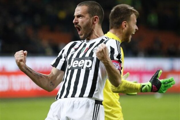 Juventus' Leonardo Bonucci celebrates past his teammate goalkeeper Neto after scoring decisive goal that gave his team a 5-2 win over Inter Milan,  a penalty shootout during the Italian Cup second leg semifinal soccer match, at the San Siro stadium in Milan, Italy, Wednesday, March 2, 2016. (AP Photo/Antonio Calanni)