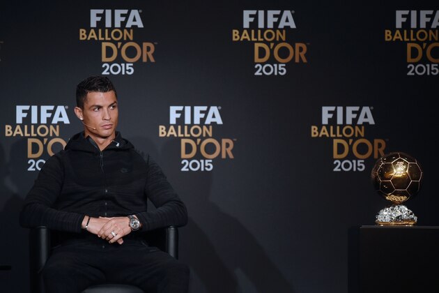Real Madrid and Portugal's forward Cristiano Ronaldo sits next to the Ballon d'Or trophy as he gives a press conference ahead of the 2015 FIFA Ballon d'Or award ceremony at the Kongresshaus in Zurich on January 11, 2016.   AFP PHOTO / OLIVIER MORIN / AFP / OLIVIER MORIN        (Photo credit should read OLIVIER MORIN/AFP/Getty Images)