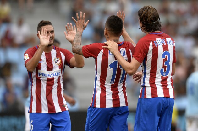 Atletico Madrid's Argentinian midfielder Angel Correa (C) celebrates with teammates midfielder Koke (L) and Brazilian defender Filipe Luis after scoring during the Spanish league football match RC Celta de Vigo vs Club Atletico de Madrid at the Balaidos stadium in Vigo on September 10, 2016. / AFP / MIGUEL RIOPA        (Photo credit should read MIGUEL RIOPA/AFP/Getty Images)
