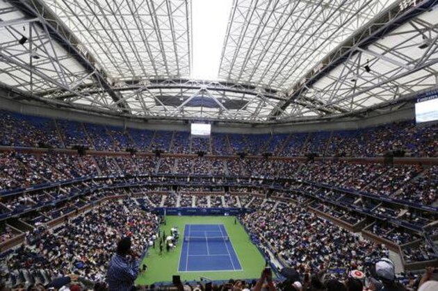 The retractable roof closes over Arthur Ashe Stadium in the second set between Gael Monfils, of France, and Lucas Pouille, of France, as rain begins to fall during the quarterfinals of the U.S. Open tennis tournament, Tuesday, Sept. 6, 2016, in New York. (AP Photo/Kathy Willens)