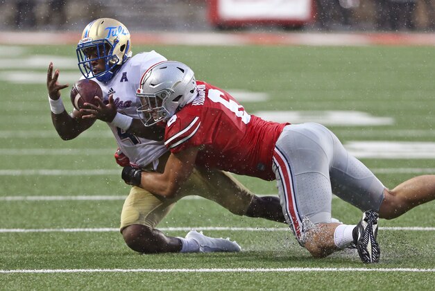 Sep 10, 2016; Columbus, OH, USA; Tulsa Golden Hurricane running back D'Angelo Brewer (4) makes a catch as he is tackle by Ohio State Buckeyes defensive end Sam Hubbard (6) in the second half against at Ohio Stadium. Ohio State won 48-3. Mandatory Credit: Aaron Doster-USA TODAY Sports