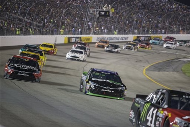 Denny Hamlin rounds Turn 1 followed by Martin Truex Jr. during the NASCAR Sprint Cup auto race at Richmond International Raceway in Richmond, Va., Saturday, Sept. 10, 2016. (AP Photo/Chet Strange)