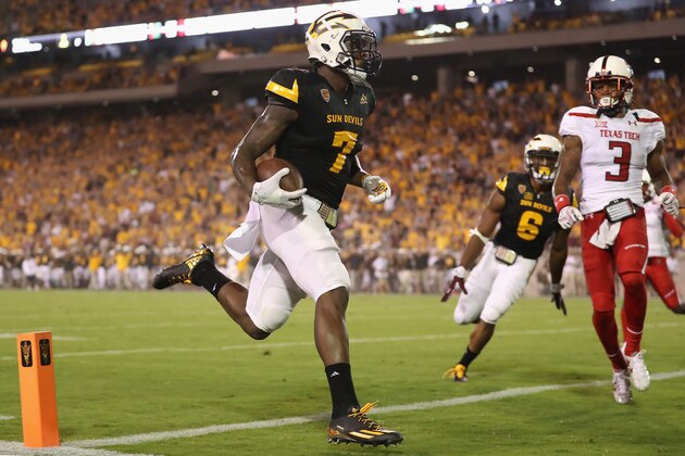TEMPE, AZ - SEPTEMBER 10: Running back Kalen Ballage #7 of the Arizona State Sun Devils scores a 39 yard touchdown rush against defensive back D.J. Polite-Bray #3 of the Texas Tech Red Raiders during the first half of the college football game at Sun Devil Stadium on September 10, 2015 in Tempe, Arizona. (Photo by Christian Petersen/Getty Images) TEMPE, AZ - SEPTEMBER 10: Running back Kalen Ballage #7 of the Arizona State Sun Devils scores a 39 yard touchdown rush against defensive back D.J. Polite-Bray #3 of the Texas Tech Red Raiders during the first half of the college football game at Sun Devil Stadium on September 10, 2015 in Tempe, Arizona. (Photo by Christian Petersen/Getty Images)