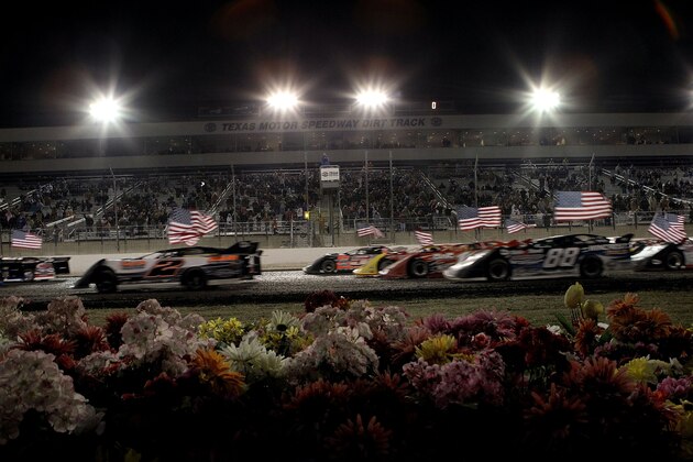 FORT WORTH, TX - MARCH 05:  American flags wave as Super Late models prepare to race in the Texas World Dirt Track O'Reilly Auto Parts SUPR Late Model Championship at Texas Motor Speedway on March 5, 2011 in Fort Worth, Texas.  (Photo by Ronald Martinez/Getty Images for TMS)