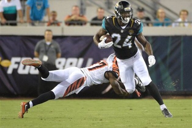 Jacksonville Jaguars running back T.J. Yeldon (24) slips past Cincinnati Bengals cornerback Chris Lewis-Harris (37) for a gain during the first half of an NFL preseason football game in Jacksonville, Fla., Sunday, Aug. 28, 2016.(AP Photo/Phelan M. Ebenhack)