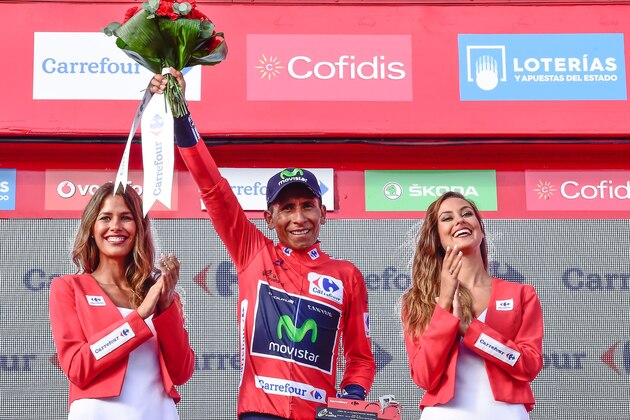 Movistar's Colombian cyclist Nairo Quintana celebrates on the podium retaining the red jersey after 20th stage of the 71st edition of 'La Vuelta' Tour of Spain, a 184km route Benidorm to Alto de Aitana, on September 10, 2016. / AFP / JOSE JORDAN        (Photo credit should read JOSE JORDAN/AFP/Getty Images)