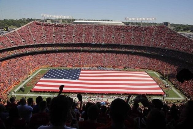 A giant flag is spread over the field at Arrowhead Stadium to commemorate Sept. 11, before an NFL football game between the Kansas City Chiefs and the San Diego Chargers in Kansas City, Mo., Sunday, Sept. 11, 2016. (AP Photo/Charlie Riedel)