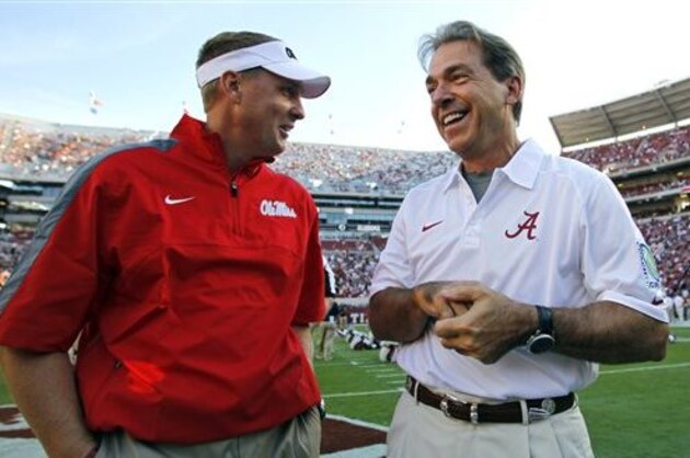 FILE - In this Sept. 28, 2013, file photo, Alabama head coach Nick Saban talks with Mississippi head coach Hugh Freeze before an NCAA college football game in Tuscaloosa, Ala. Alabama and Mississippi are two SEC West teams who have avoided trouble in coasting into a game that pits the nation’s top scoring offense against the Crimson Tide’s typically strong defense. (AP Photo/Butch Dill, File)