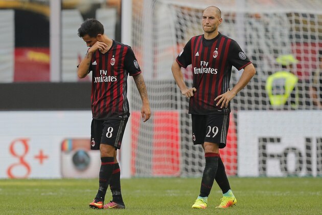 AC Milan's Spanish midfielder Suso (L) and AC Milan's defender Gabriel Paletta react at the end of the Italian Serie A football match AC Milan Vs Udinese on September 11, 2016 at the San Siro stadium in Milan.  / AFP / MARCO BERTORELLO        (Photo credit should read MARCO BERTORELLO/AFP/Getty Images)