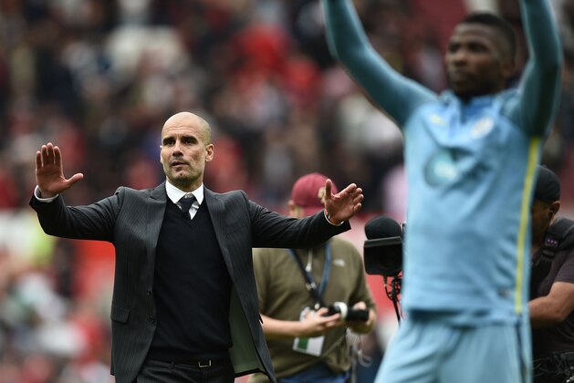 Manchester City's Spanish manager Pep Guardiola and his players celebrate on the pitch after the English Premier League football match between Manchester United and Manchester City at Old Trafford in Manchester, north west England, on September 10, 2016.
Pep Guardiola savoured a derby success over arch-rival Jose Mourinho on Saturday as Manchester City beat Manchester United 2-1 in an engrossing Premier League clash.
 / AFP / Oli SCARFF / RESTRICTED TO EDITORIAL USE. No use with unauthorized audio, video, data, fixture lists, club/league logos or 'live' services. Online in-match use limited to 75 images, no video emulation. No use in betting, games or single club/league/player publications.  /         (Photo credit should read OLI SCARFF/AFP/Getty Images)