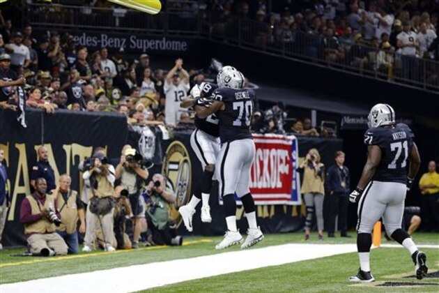 Oakland Raiders running back Latavius Murray (28) celebrates his touchdown with offensive tackle Kelechi Osemele (70) in the first half of an NFL football game in New Orleans, Sunday, Sept. 11, 2016. (AP Photo/Butch Dill)