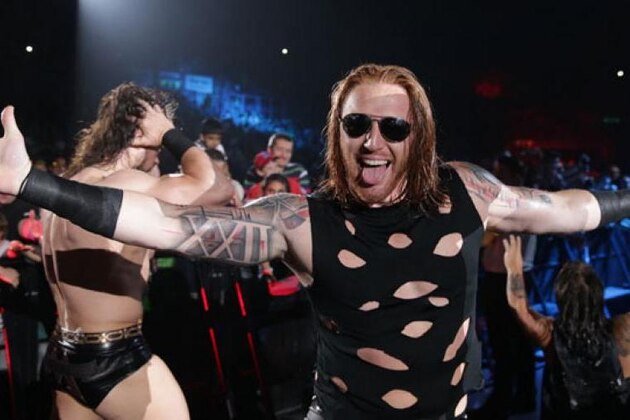 WWE wrestler Jimmy Usos, right, puts down Kofi Kingston during WWE Live India Tour, in New Delhi, Friday, Jan. 15, 2016. WWE returned to Indian after a gap of 13 years to entertain their fans. (AP Photo/Manish Swarup)