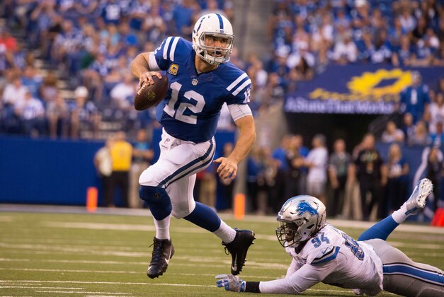 Sep 11, 2016; Indianapolis, IN, USA;  Indianapolis Colts quarterback Andrew Luck (12) avoids the tackle of Detroit Lions defensive end Ezekiel Ansah (94) in the second half of the game at Lucas Oil Stadium. the Detroit Lions beat the Indianapolis Colts by the score of 39-35. Mandatory Credit: Trevor Ruszkowski-USA TODAY Sports