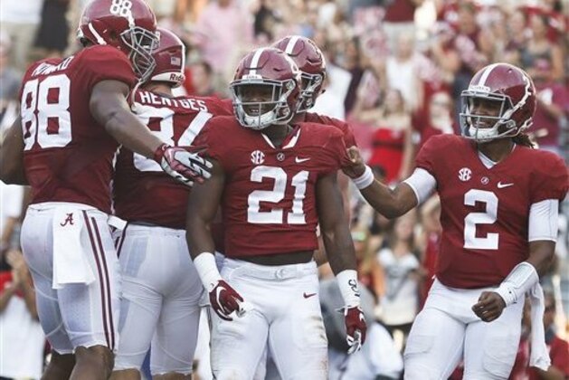 Alabama running back B.J. Emmons, center, quarterback Jalen Hurts, right, and offensive lineman Jonah Williams, back, celebrate after Emmons scores during the second half of an NCAA college football game against Western Kentucky, Saturday, Sept. 10, 2016, in Tuscaloosa, Ala. (AP Photo/Brynn Anderson)