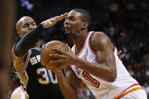 Miami Heat forward Chris Bosh (1) goes up for a shot against San Antonio Spurs forward David West (30) during the first half of an NBA basketball game, Tuesday, Feb. 9, 2016, in Miami. (AP Photo/Wilfredo Lee)