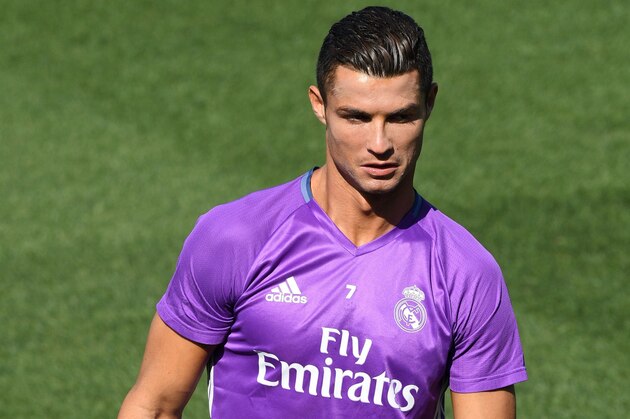 Real Madrid's Portuguese forward Cristiano Ronaldo stands on the pitch during a training session at Valdebebas training ground in Madrid on September  9, 2016, on the eve of the Spanish League match Real Madrid CF vs Osasuna. / AFP / GERARD JULIEN        (Photo credit should read GERARD JULIEN/AFP/Getty Images)