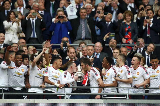 LONDON, ENGLAND - MAY 21:  Wayne Rooney and Michael Carrick of Manchester United kiss the trophy after winning The Emirates FA Cup Final match between Manchester United and Crystal Palace at Wembley Stadium on May 21, 2016 in London, England.  (Photo by Paul Gilham/Getty Images)