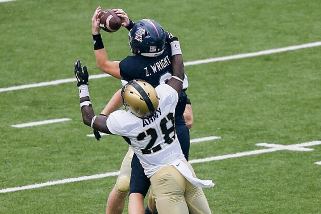 HOUSTON, TX - OCTOBER 24:  Zach Wright #9 of the Rice Owls makes a catch in the fourth quarter in front of Brandon Jackson #28 of the Army Black Knights at Rice Stadium on October 24, 2015 in Houston, Texas.  (Photo by Bob Levey/Getty Images)
