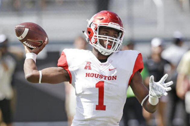 FILE - In this Oct. 24, 2015, file photo, Houston quarterback Greg Ward Jr. looks for a receiver against Central Florida during an NCAA college football game in Orlando, Fla. If Ward, who passed for 2,828 yards, ran for 1,108 yards and accounted for 38 touchdowns last season, has a big game against Oklahoma and leads the Cougars to an upset, he can vault himself into the heart of a crowded field of Heisman contenders that includes three of the top four vote-getters from last season. (AP Photo/John Raoux, File)