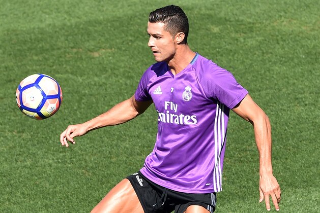 Real Madrid's Portuguese forward Cristiano Ronaldo plays with a ball during a training session at Valdebebas training ground in Madrid on September 9, 2016, on the eve of the Spanish League match Real Madrid CF vs Osasuna. / AFP / GERARD JULIEN        (Photo credit should read GERARD JULIEN/AFP/Getty Images)