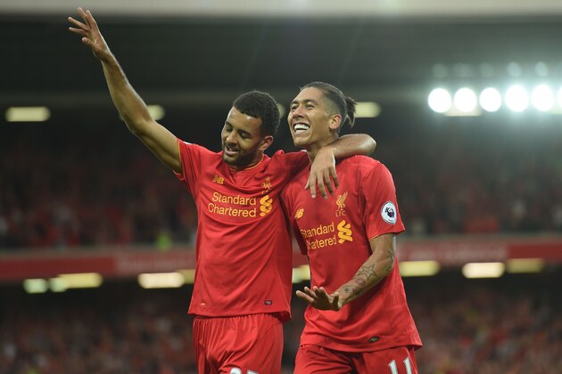 Liverpool's Brazilian midfielder Roberto Firmino (R) celebrates with Liverpool's English defender Kevin Stewart after scoring their fourth goal during the English Premier League football match between Liverpool and Leicester City at Anfield in Liverpool, north west England on September 10, 2016. / AFP / Paul ELLIS / RESTRICTED TO EDITORIAL USE. No use with unauthorized audio, video, data, fixture lists, club/league logos or 'live' services. Online in-match use limited to 75 images, no video emulation. No use in betting, games or single club/league/player publications.  /         (Photo credit should read PAUL ELLIS/AFP/Getty Images)