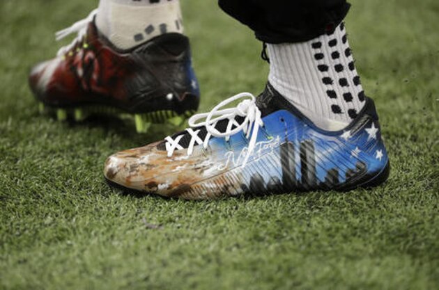 Atlanta Falcons' Mohamed Sanu warms up wearing cleats in remembrance of 9/11 before the first half of an NFL football game, Sunday, Sept. 11, 2016, in Atlanta. (AP Photo/David Goldman)