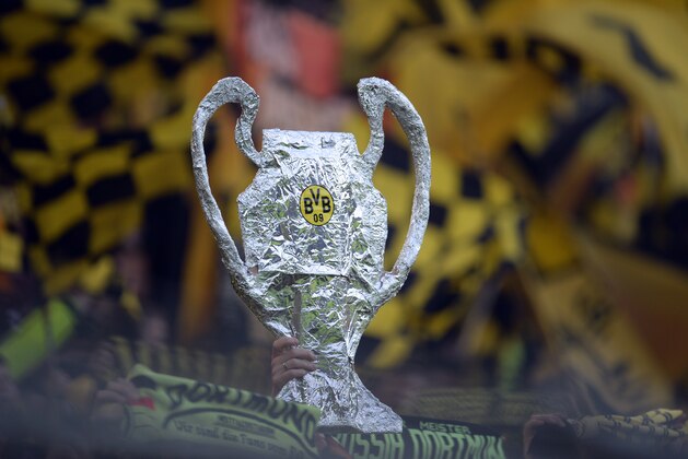 Dortmund's supporters hold up a mockup of the Champions League trophy prior to the UEFA Champions League semi final first leg football match between Borussia Dortmund and Real Madrid on April 24, 2013 in Dortmund, western Germany. Dortmund won the match 4-1.      AFP PHOTO / PATRIK STOLLARZ        (Photo credit should read PATRIK STOLLARZ/AFP/Getty Images)