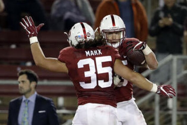 Stanford running back Christian McCaffrey (5) celebrates with teammate Daniel Marx (35) after McCaffrey's 41-yard touchdown run against Kansas State during the second half of an NCAA college football game Friday, Sept. 2, 2016, in Stanford, Calif. Stanford won 26-13. (AP Photo/Marcio Jose Sanchez)