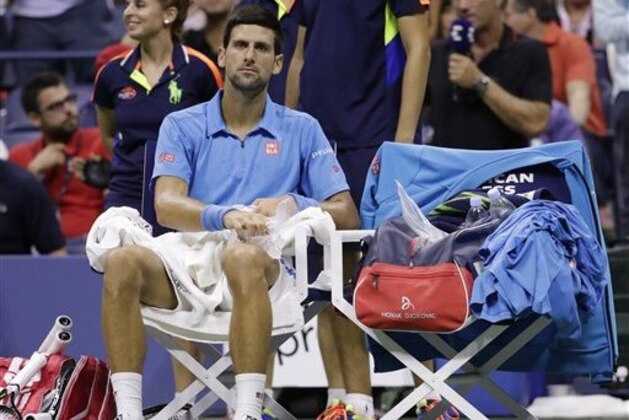 Novak Djokovic, of Serbia, applies ice to his leg between games against Stan Wawrinka, of Switzerland, during the men's singles final of the U.S. Open tennis tournament, Sunday, Sept. 11, 2016, in New York. (AP Photo/Julio Cortez)