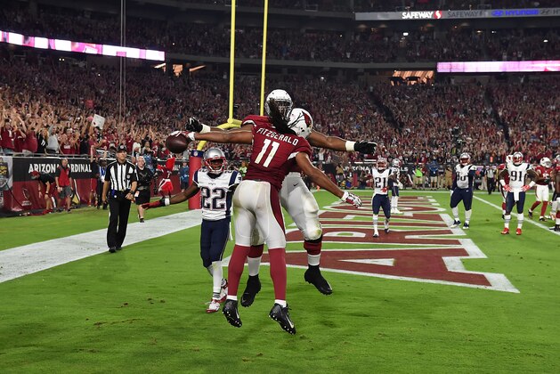 GLENDALE, AZ - SEPTEMBER 11:  Wide receiver Larry Fitzgerald #11 of the Arizona Cardinals is congratulated by teammate Earl Watford #78 after catching his 100th career touchdown pass in the fourth quarter of the NFL game against the New England Patriots at University of Phoenix Stadium on September 11, 2016 in Glendale, Arizona.  (Photo by Norm Hall/Getty Images)