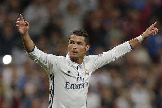 Real Madrid's Cristiano Ronaldo celebrates scoring his side's first goal during a Champions League, Group F soccer match between Real Madrid and Sporting, at the Santiago Bernabeu stadium in Madrid, Spain, Wednesday, Sept. 14, 2016. Real Madrid won with a 2-1 score. (AP Photo/Daniel Ochoa de Olza)