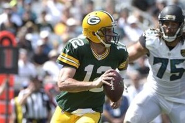 Green Bay Packers quarterback Aaron Rodgers (12) scrambles for yardage past Jacksonville Jaguars defensive end Jared Odrick (75) during the second half of an NFL football game in Jacksonville, Fla., Sunday, Sept. 11, 2016. The Packers won 27-23. (AP Photo/Phelan M. Ebenhack)