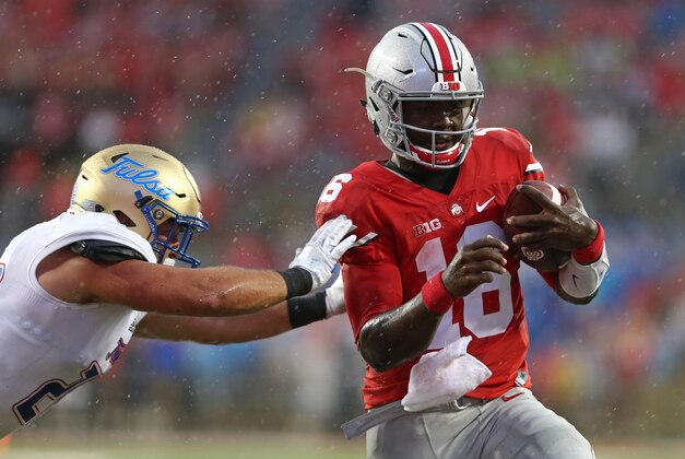 Sep 10, 2016; Columbus, OH, USA; Ohio State Buckeyes quarterback J.T. Barrett (16) carries the ball for a touchdown as he is shoved by Tulsa Golden Hurricane linebacker Craig Suits (28) in the second half at Ohio Stadium. Ohio State won 48-3. Mandatory Credit: Aaron Doster-USA TODAY Sports