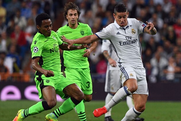 Sporting's Brazilian midfielder Elias (L) vies with Real Madrid's Colombian midfielder James Rodriguez during the UEFA Champions League football match Real Madrid CF vs Sporting CP at the Santiago Bernabeu stadium in Madrid on September 14, 2016. / AFP / GERARD JULIEN        (Photo credit should read GERARD JULIEN/AFP/Getty Images)