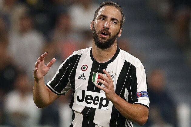 Juventus' Argentinian forward Gonzalo Higuain reacts during the UEFA Champions League football match between Juventus and FC Sevilla on September 14, 2016 at the Juventus Stadium in Turin. / AFP / MARCO BERTORELLO        (Photo credit should read MARCO BERTORELLO/AFP/Getty Images)